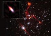 This composite image, taken by the Very Large Array and Hubble, shows the galaxy cluster MACS J0717.5+3745. Pullout shows the distant galaxy J0717+3745, far beyond the cluster, and likely the faintest radio-emitting object ever detected. The prominent red-orange objects are radio relics -- large structures possibly caused by shock waves -- inside MACS J0717.5+3745. Image credit: Heywood et al. / Sophia Dagnello, NRAO / AUI / NSF / STScI.